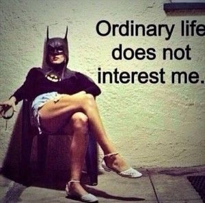 Photo of a woman in a Batwoman costume with the words "Ordinary life does not interest me"