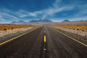 Photo of a road heading towards mountains